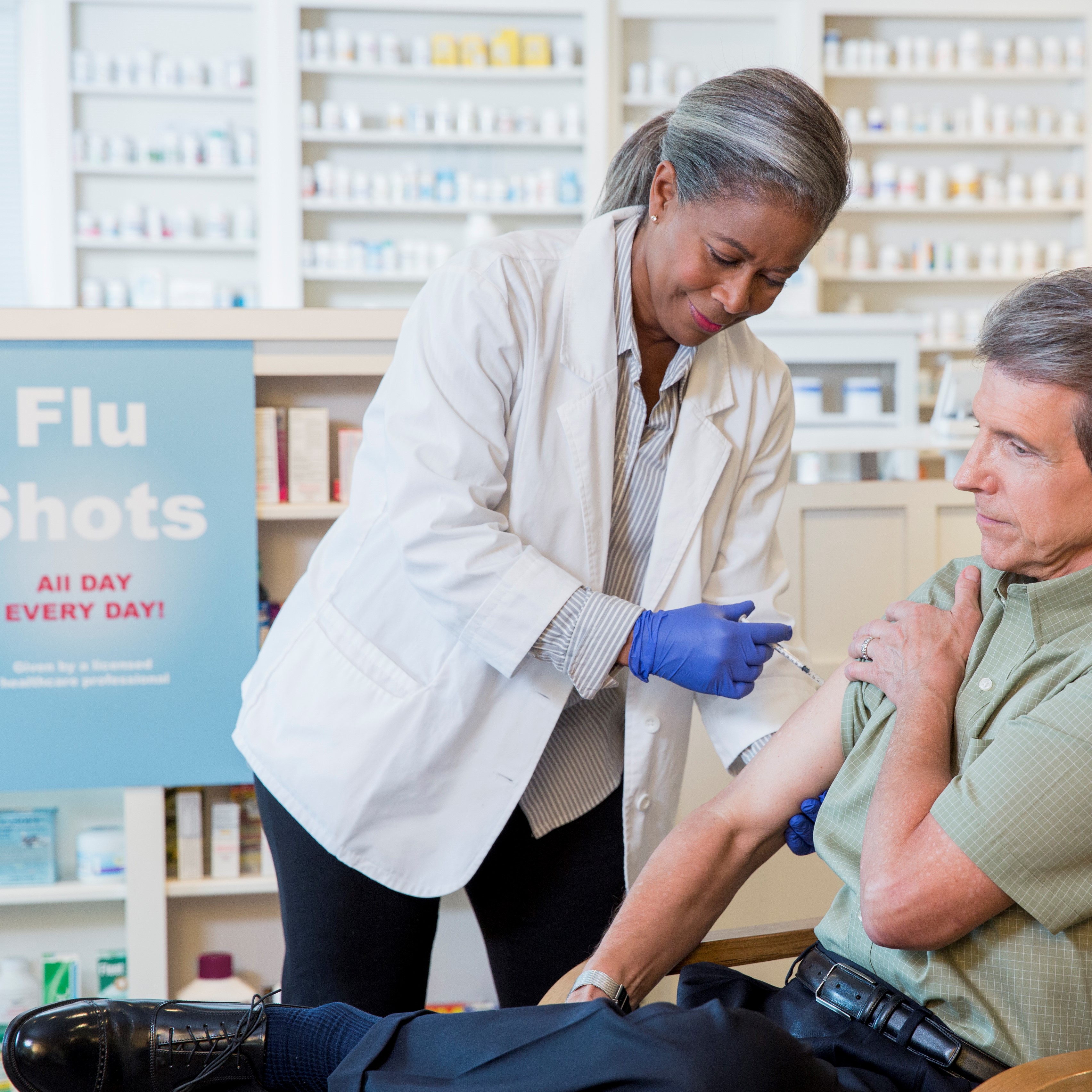 Man getting flu shot in pharmacy
