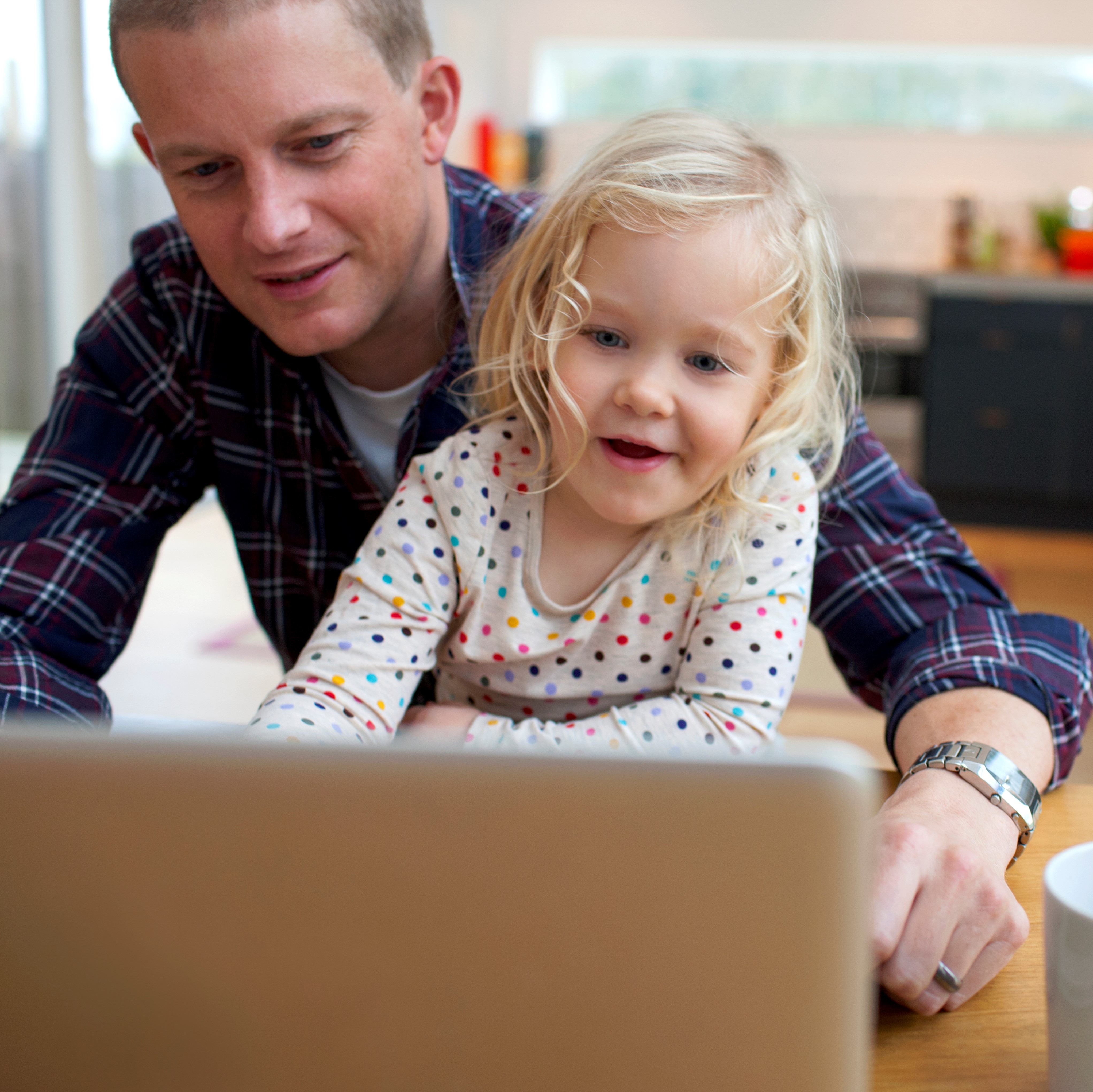Dad and daughter on computer